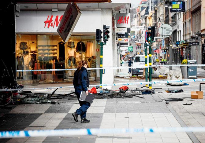 A police officer at the site in central Stockholm. Pic/AFP