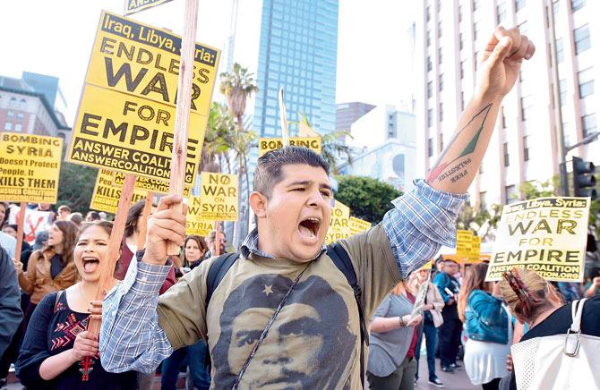 Protests at US air strikes against Syria in Los Angeles.  It has fuelled calls for a diplomatic push to end the six-year war. Pic/AFP