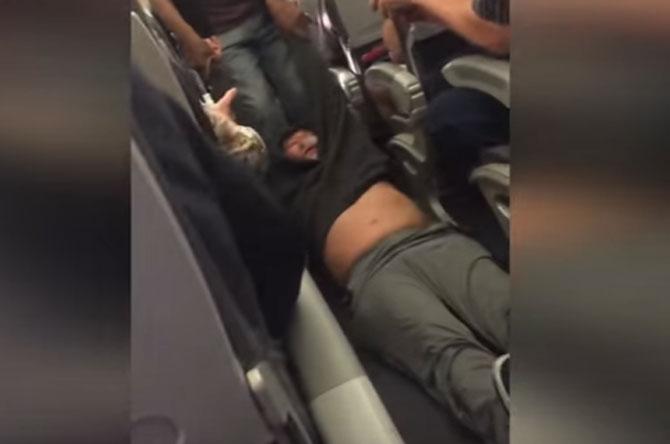 Screengrab of a video showing David Dao getting forcibly deplaned