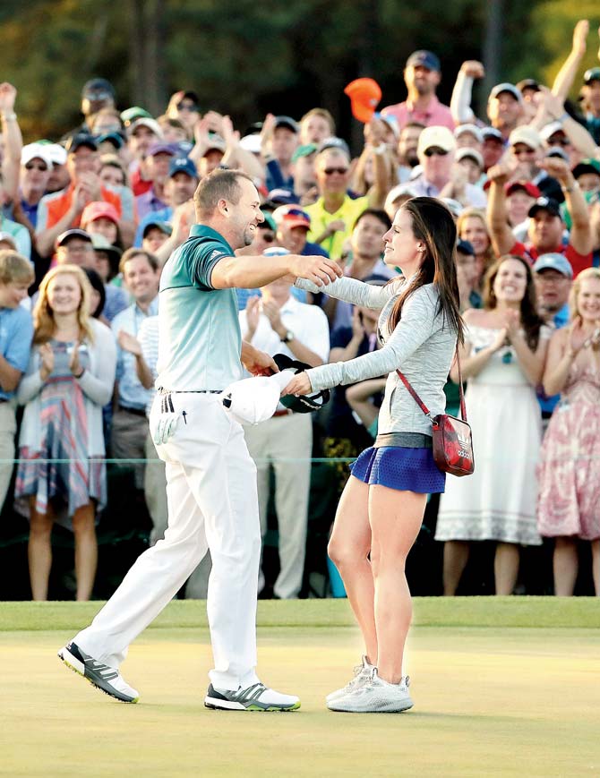 Sergio Garcia embraces fiancée Angela Akins celebrating his Masters win at the Augusta National Golf Club on Sunday. Pics/Getty Images