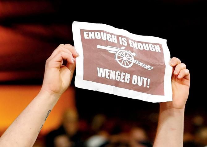 An Arsenal fan protests against coach Arsene Wenger after their defeat to Crystal Palace in an EPL match on Monday. Pic/Getty Images