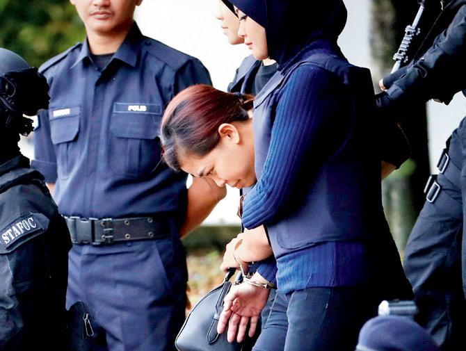  Indonesian suspect Siti Aisyahâu00c2u0080u00c2u0088(C) escorted by police. Pic/AP