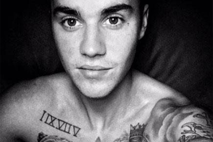 Justin Bieber shows off his tattoos in shirtless selfie