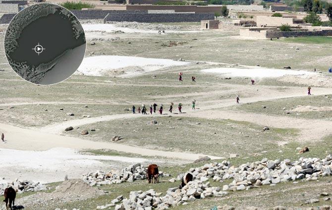 Afghan villagers flee from a village near the site of USâu00c2u0080u00c2u0088bombing in Achin district; (inset) A video grab shows bomb striking ISISâu00c2u0080u00c2u0088hideouts. Pics/AFP