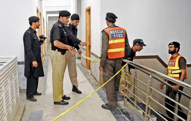 Pakistani police officials inspect a hostel at Abdul Wali Khan University in Mardan. Pic/AFP