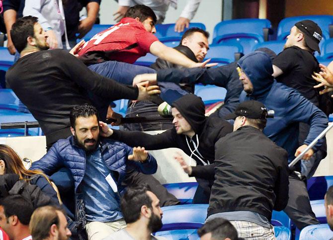 Besiktas Lyon supporters fight before the UEFA Europa League first leg quarter-final 