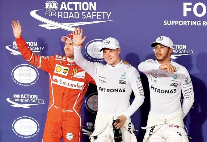 Mercedes’ Valtteri Bottas (centre) celebrates after taking pole with teammate Lewis Hamilton (right) and Ferrari’s Sebastian Vettel at the end of qualifying in Manama on Saturday. Pic/AFP