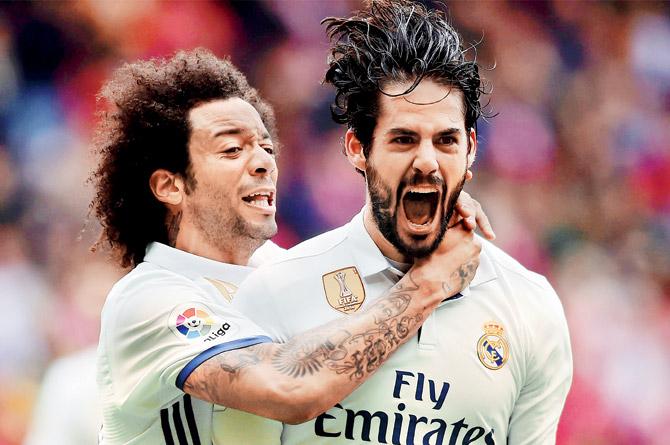 Isco (right) celebrates scoring the winner against Sporting with Marcelo on Saturday. Pic/AFP