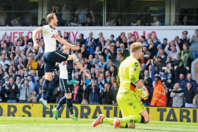English striker Harry Kane (left) celebrates after scoring Tottenham Hotspur’s third goal as Bournemouth goalkeeper Artur Boruc (right) reacts during the English Premier League tie in London on Saturday. Pic/AFP