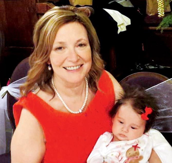 Diana Robertson holds up the youngest generation of the family — her 6-month-old granddaughter Lottie
