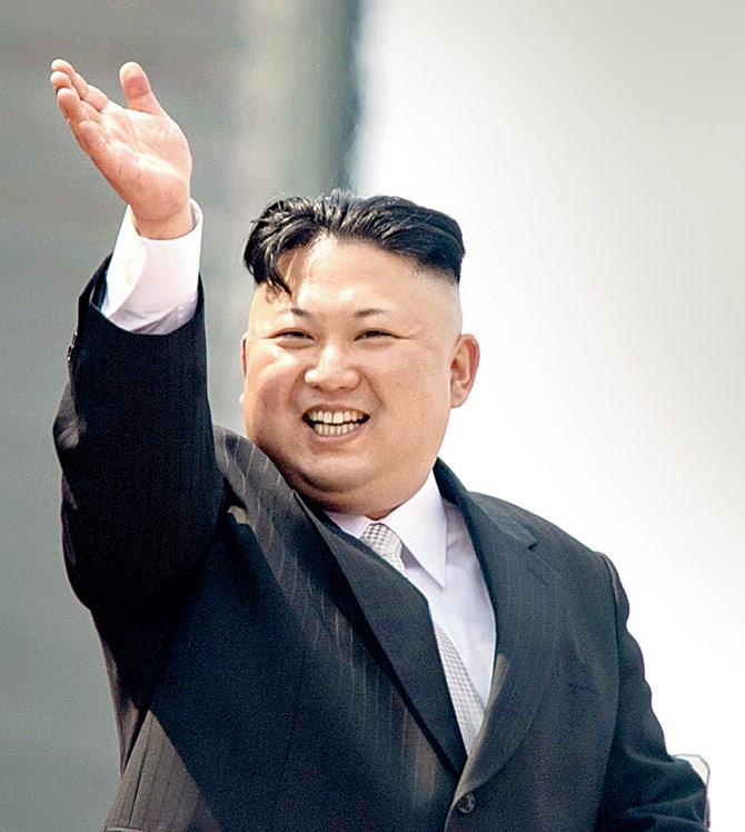 N Korean leader Kim Jong-Un waves from a balcony. Ranks of goose-stepping soldiers followed by tanks paraded in Pyongyang with tensions mounting over his nuclear ambitions. Pic/AFP