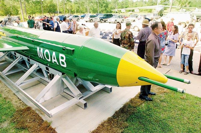 A group gathers around a GBU-43B, or massive ordnance air blast (MOAB) weapon, on display at the Air Force Armament Museum on Eglin Air Force Base near Valparaiso, Fla. US forces in Afghanistan struck an Islamic State tunnel complex in eastern Afghanistan with a GBU-43B, the largest non-nuclear weapon ever used in combat by the US military. Pic/AP/PTI