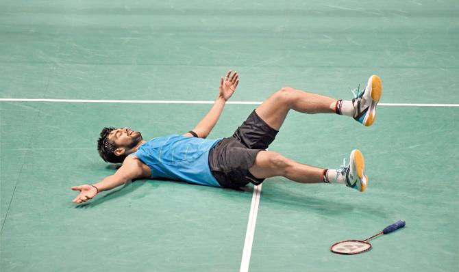 India’s B Sai Praneeth lies on the court after beating K Srikanth in the Singapore Open singles final yesterday. (Above) Praneeth with Srikanth (left). Pics/AFP