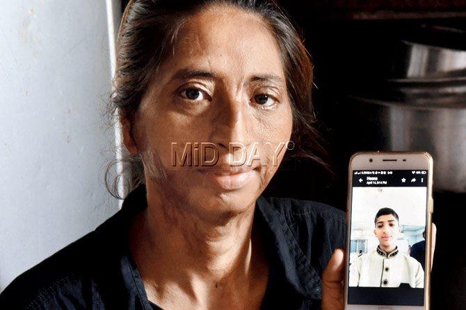 Daulatbi Khan, who runs an NGO, holds up a phone with her son, Aqib