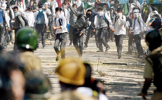 Students clash with security forces near a college in Srinagar. Pic/AFP