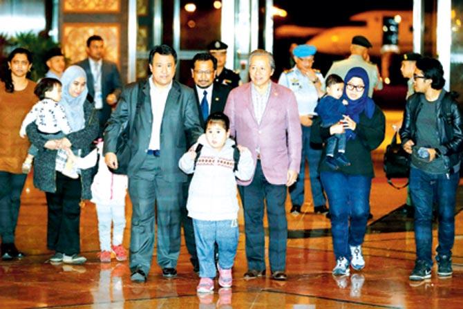 The Malaysians, who were stranded in Pyongyang, North Korea , walk with Malaysia