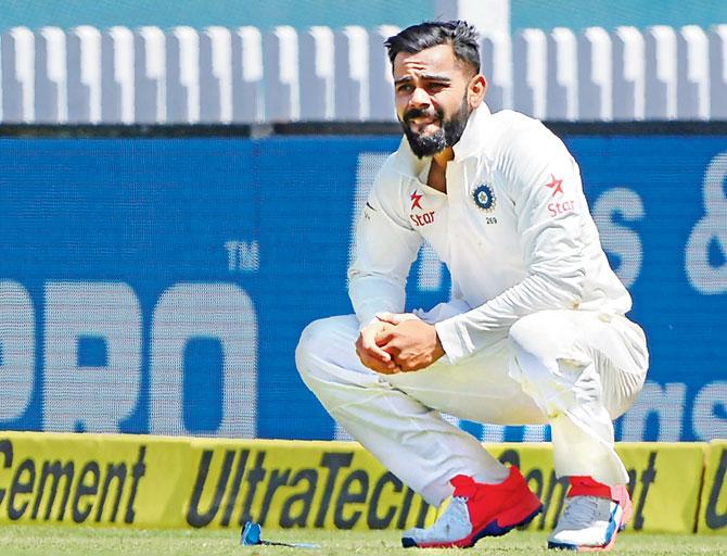 Virat Kohli reacts after he was injured while fielding during Day One of the third Test against Australia in Ranchi on March 16. Pic/AFP