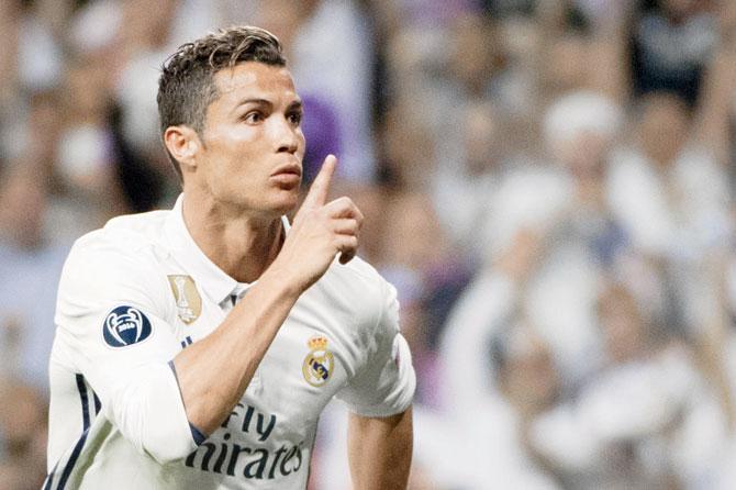 Real Madrid’s Cristiano Ronaldo celebrates scoring against Bayern Munich by gesturing to a section of the home fans at the Bernabeu Stadium to stop booing him during their Champions League quarter-final second leg in Madrid on Tuesday. Pic/AFP