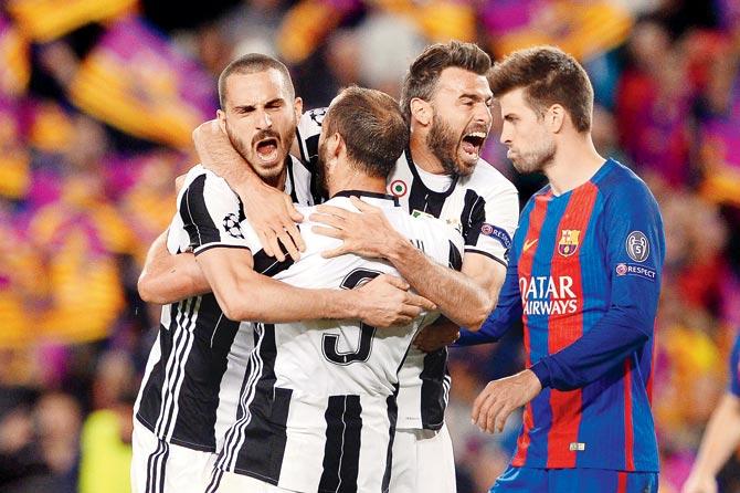 Juventus players celebrate while Barcelona’s Gerard Pique (right) walks away after the Champions League quarter-final second leg at Camp Nou ended 0-0 on Wednesday night sending Juve into the semis. Pic/AFP