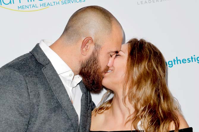 Travis Browne and the MMA star kiss at an awards function in Beverly Hills, California last year 