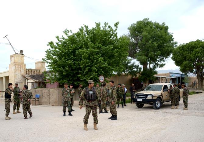 Afghan security personnel keep watch near the site of an ongoing attack on an army compound in Dihdadi District of Balkh province. Pic/AFP