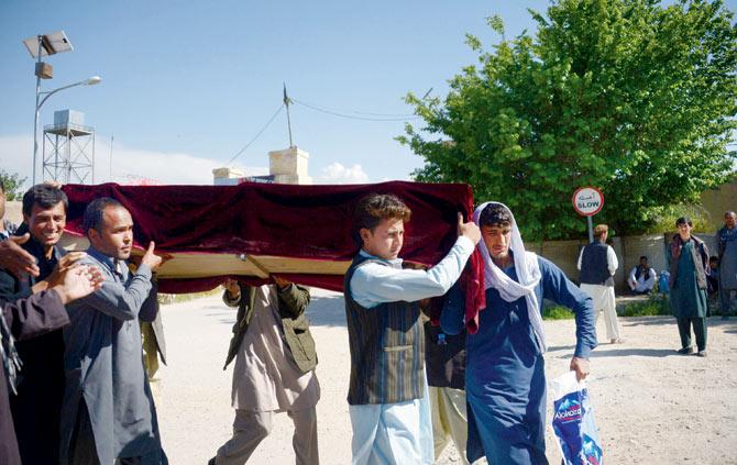 Afghan relatives carry the coffin of a Afghan National army (ANA) soldier killed in a Taliban attack