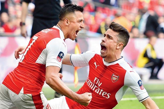 Arsenal’s Alexis Sanchez (left) celebrates his goal with teammate Gabriel in the FA Cup semi-final vs Man City in London yesterday. Pic/AFP