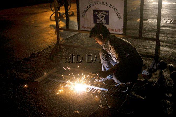 Apr 24 A worker repairs the damaged grill of the drain last night.
