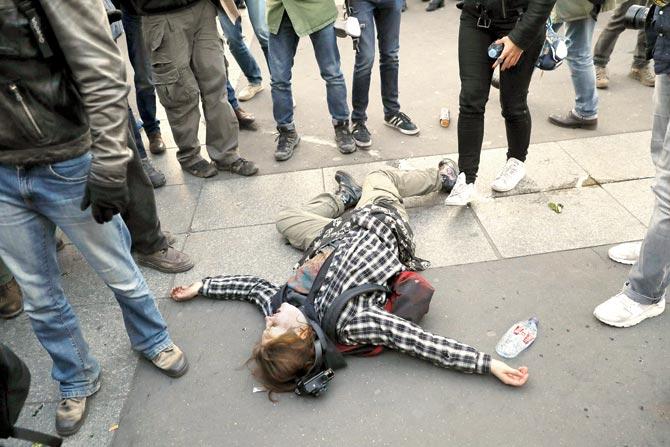 A wounded protester on the ground during a demonstration by  anti-fascists in Paris following the results of the first round. Pic/AFP