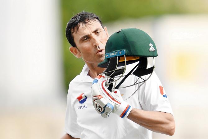Younis Khan kisses his helmet after becoming the first Pakistan batsman to score 10,000 runs in Tests on Sunday. Pic/AFP