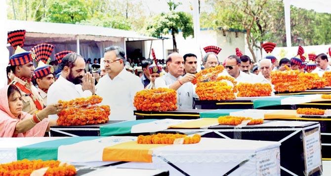 Home Minister Rajnath Singh pays tribute, along with Chhattisgarh CMâu00c2u0080u00c2u0088Raman Singh, to the fallen jawans in Raipur yesterday. Pic/PTI