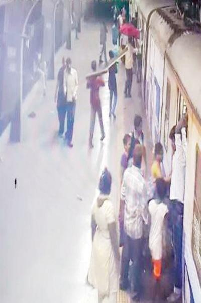 The accused seen in CCTV footage at Sandhurst station, boarding a train with the beam