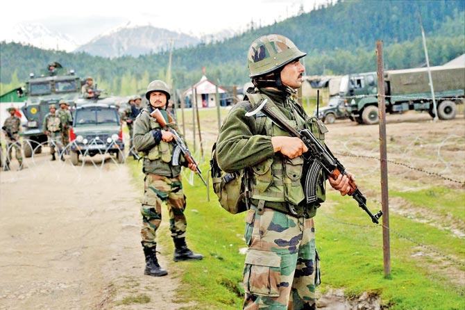 Army personnel guard the Panzgam camp, which was attacked by militants on Thursday. Pic/PTI