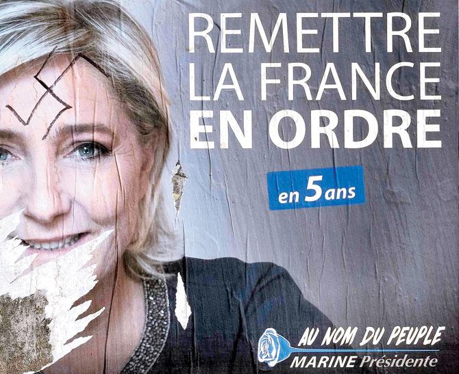 A picture in Cessales near Toulouse shows campaign poster of Marine Le Pen with Nazi graffiti