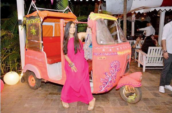 Maria Goretti poses in front of an auto rickshaw in a Goan restaurant