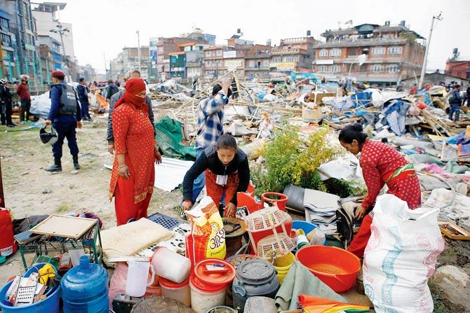 Victims of the 2015 earthquake gather their belongings, rendered homeless a second time after the Kathmandu police on March 14, 2017, demolished the largest settlement camp where 100 displaced families were staying. Pic/AFP