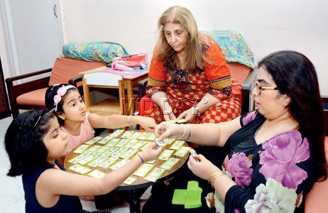 Persis Khatau ( in red) enjoys a word game with daughter Dimple Makwana (right), grand-daughters Divyana Chikhal (far left) and Jiyah Makwana. Pic/Satej Shinde