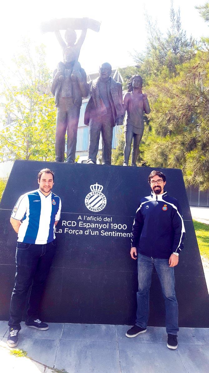 Javi Arabia (left) and Daniel Perez, members of the Federation of Catalunya fan clubs, pose at the official Espanyol fan statue at the RCD Espanyol Stadium in Barcelona on Saturday. Pic/Ashwin Ferro 
