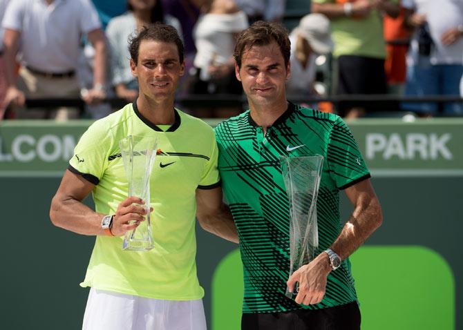 Rafael Nadal of Spain (left) and Roger Federer of Switzerland (right) pose with their trophie