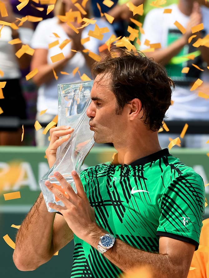 Roger Federer of Switzerland with the winners trophy after defeating Rafael Nadal. Pic/AFP