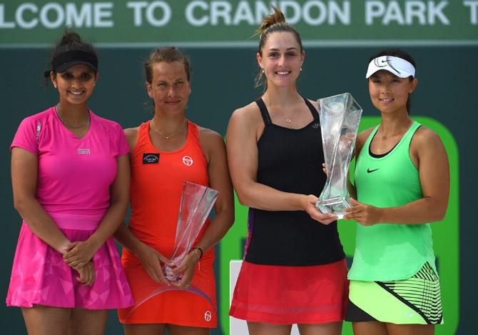 Sania Mirza of India, Barbora Strycova of the Czech Republic, Gabriela Dabrowski of Canada and Yifan Xu of Canada pose with their trophies