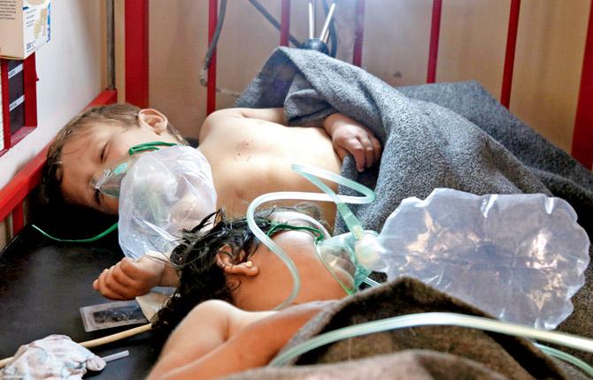 Syrian doctors treating children following the suspected chemical attack, at a makeshift hospital, in the town of Khan Sheikhoun. Pics/AFP