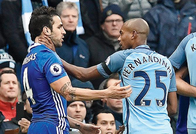 Manchester City’s Fernandinho (right) gets into a tussle with Chelsea’s Cesc Fabregas during an EPL tie in December 2016. Pic/AFP