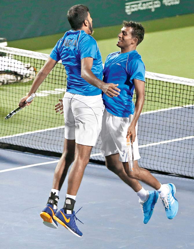 India’s Rohan Bopanna (left) and Sriram Balaji celebrate their doubles win over Uzbekistan’s Farrukh Dustov and Sanjar Fayziev with a chest bump during the Davis Cup tie in Bangalore on Saturday. Pic/PTI
