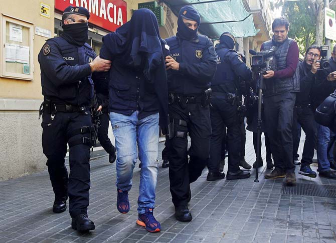 An unidentified man is detained by Mossos d