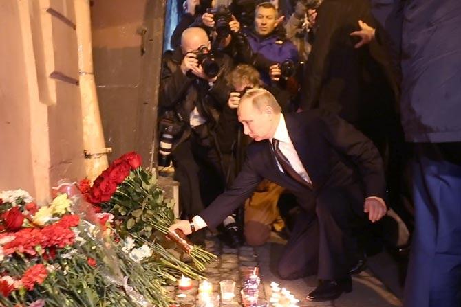 Russian President Vladimir Putin places flowers in memory of victims of the blast in the Saint Petersburg metro outside Technological Institute station on Monday. Pic/AFP