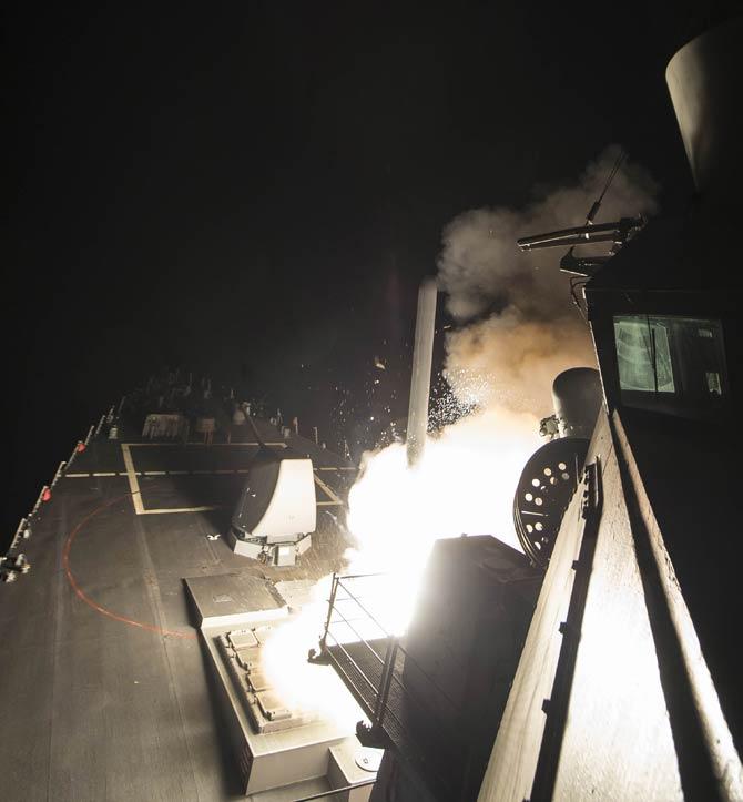 US Navy, the USS Ross fires a tomahawk land attack missile April 7, 2017, at a Syrian air force airfield. Photo/AFP