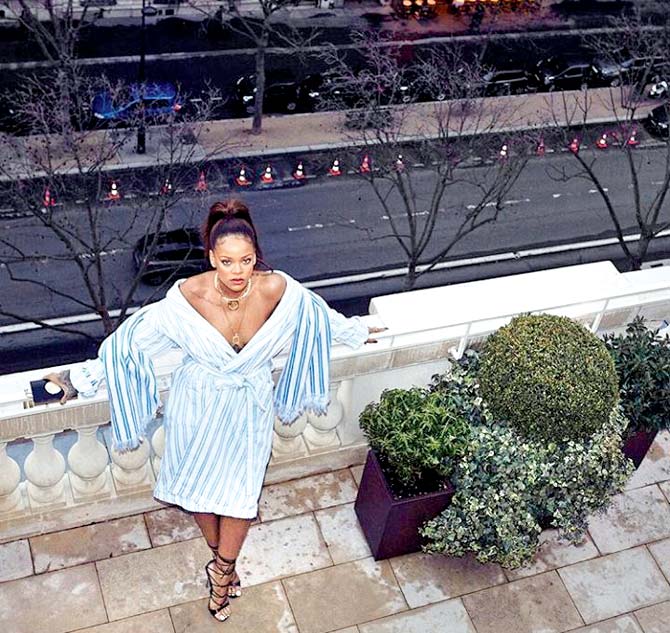 Rihanna sports a striped wrap dress; socked heels at the Fendi Roma show at Fontana di Trevi in Rome. Pics/Rihanna’s Instagram account