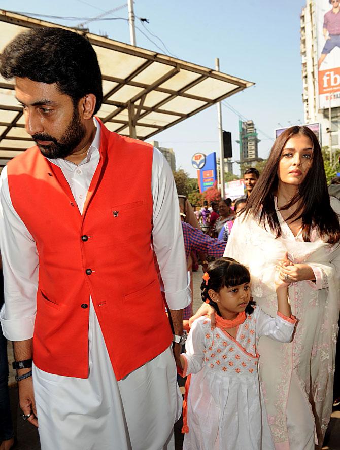 Bollywood actor Abhishek Bachchan (L) with his wife Aishwarya Rai Bachchan and daughter Aaradhya Bachchan visit the Siddhivinayak Temple in Mumbai