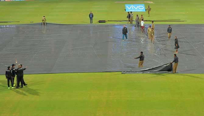 Pitch been covered by sheets as it rains during the IPL 10 match between Royal Challengers Bangalore and Sunrisers Hyderabad in Bengaluru on Tuesday. PTI